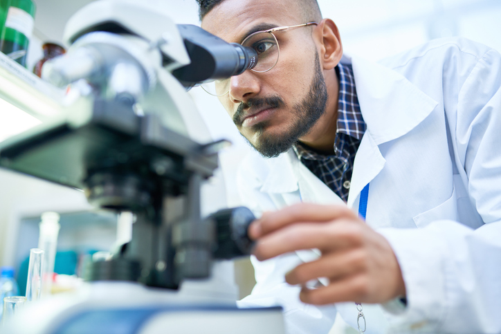 Nuclear Med Tech working with a microscope Nuclear Med Tech working with a microscope
