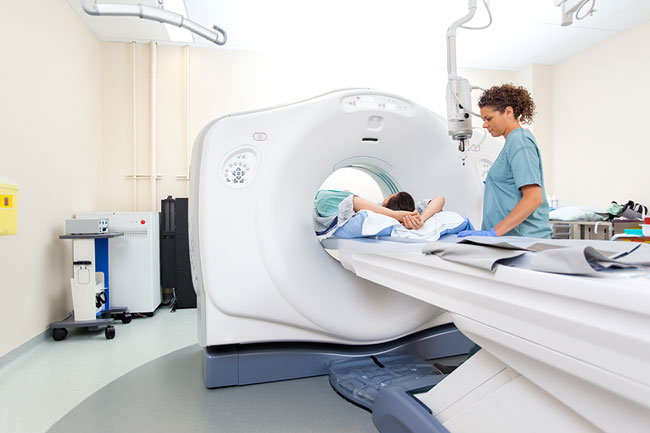 MRI Tech working with a patient during a scan MRI Tech working with a patient during a scan