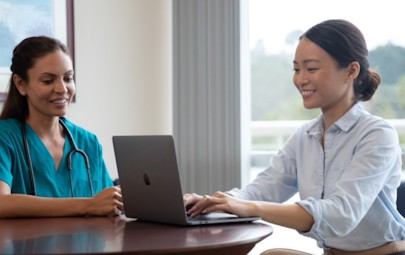 businesswoman speaking with nurse businesswoman speaking with nurse