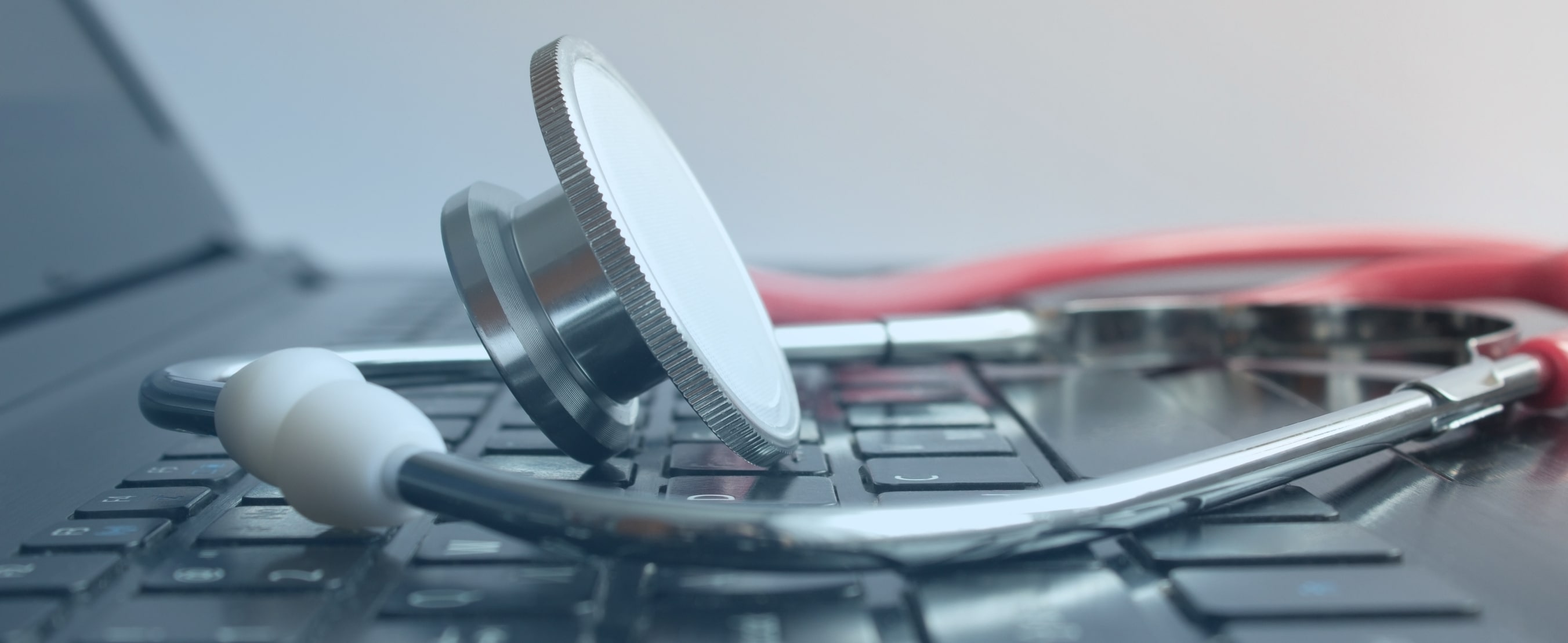stethoscope lays on keys of laptop stethoscope lays on keys of laptop