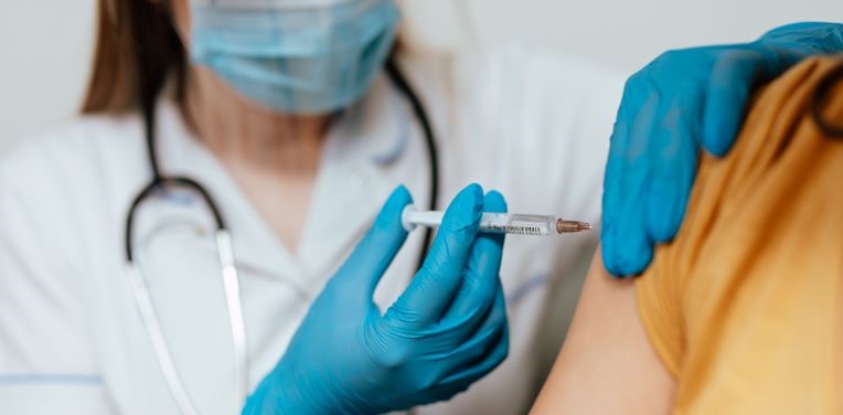 doctor administering covid vaccine doctor administering covid vaccine
