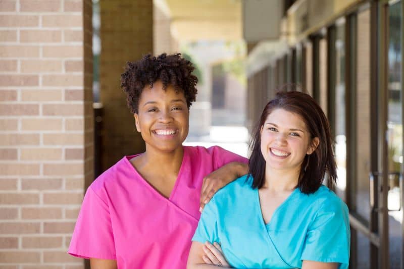 two smiling female nurses two smiling female nurses