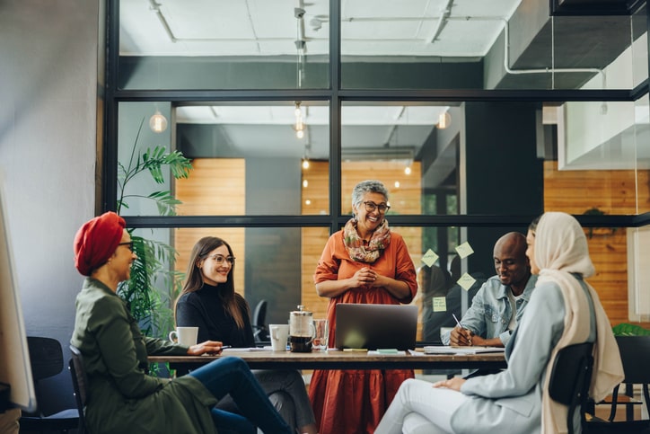 Group of many represented, diverse participants having a discussion Group of many represented, diverse participants having a discussion