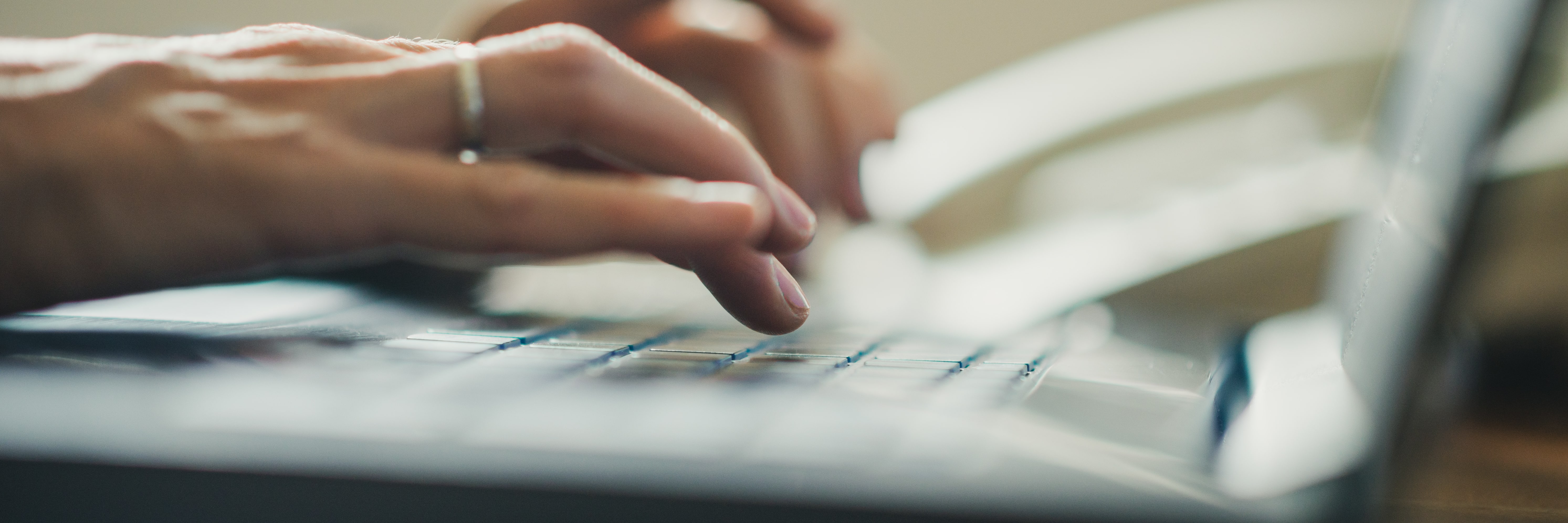 female keying on computer keyboard