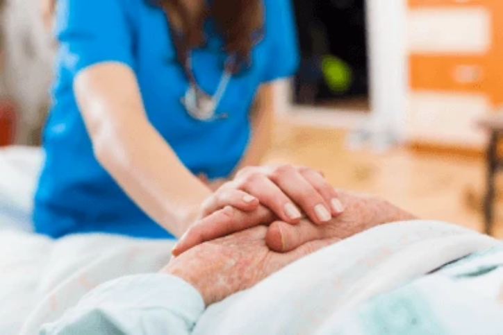 nurse with hands un top of patients hands nurse with hands un top of patients hands