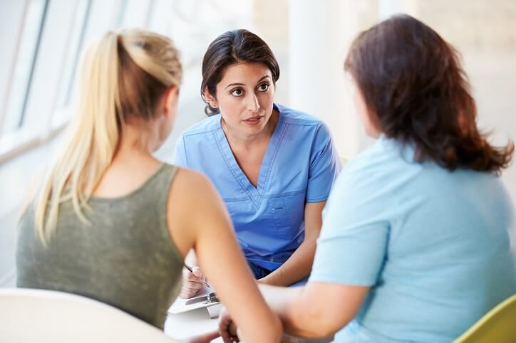 Nurse talking with a patient's family. Nurse talking with a patient's family.