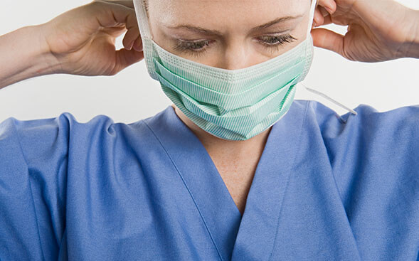 Nurse putting on mask Nurse putting on mask