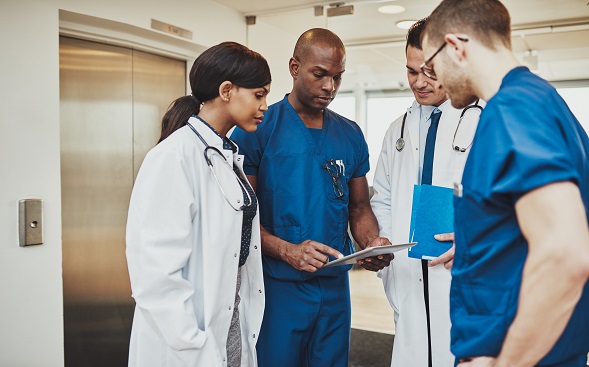 nurse and doctors reading a patient's files nurse and doctors reading a patient's files