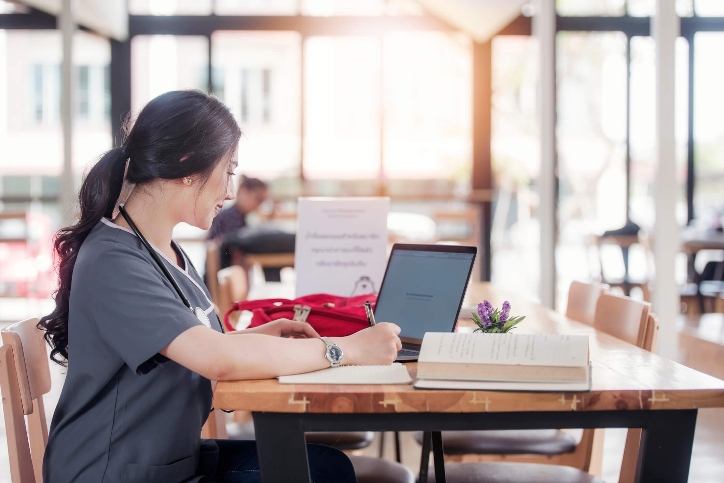 Nurse standing at a computer desk Nurse standing at a computer desk