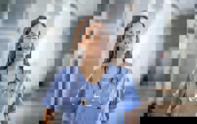 Young Nurse Standing in Hallway Young Nurse Standing in Hallway
