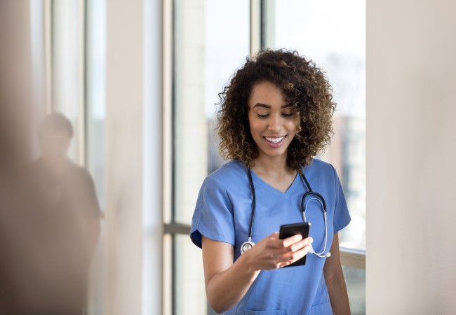 Travel Nurse Checking Her Pay on Her Phone Travel Nurse Checking Her Pay on Her Phone