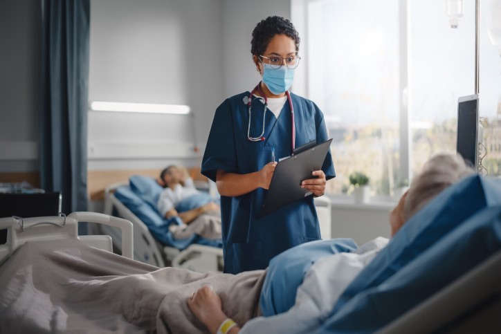 nurse looking at a patient nurse looking at a patient