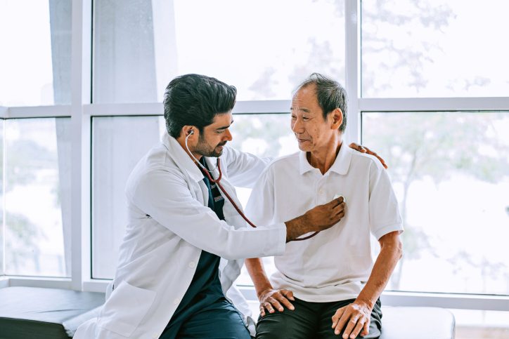 Physician listening to patients heart Physician listening to patients heart