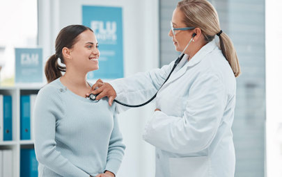 a Cardiologist listening to a patient's heart using a stethoscope a Cardiologist listening to a patient's heart using a stethoscope