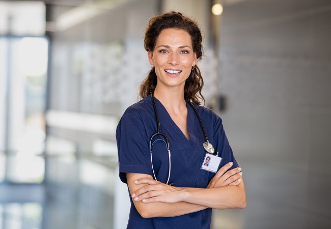 Pediatric Nurse Manager smiling in office