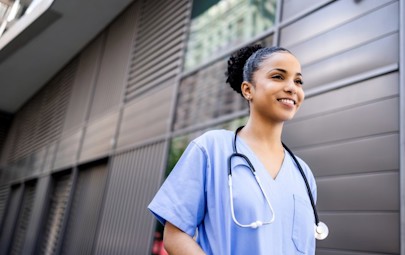 Travel nurse walking in a hospital setting Travel nurse walking in a hospital setting