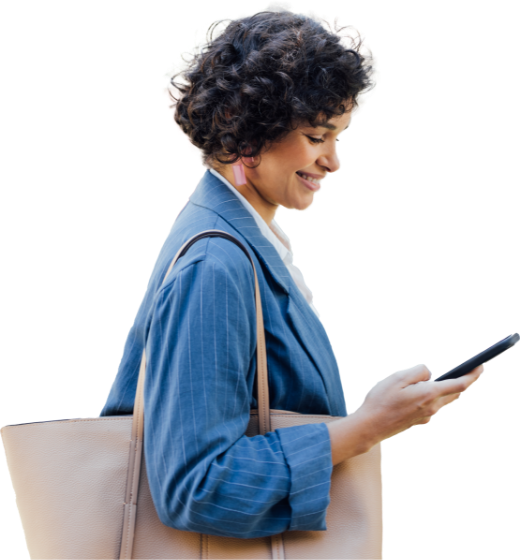 Healthcare Professional walking with her bag while on her phone.