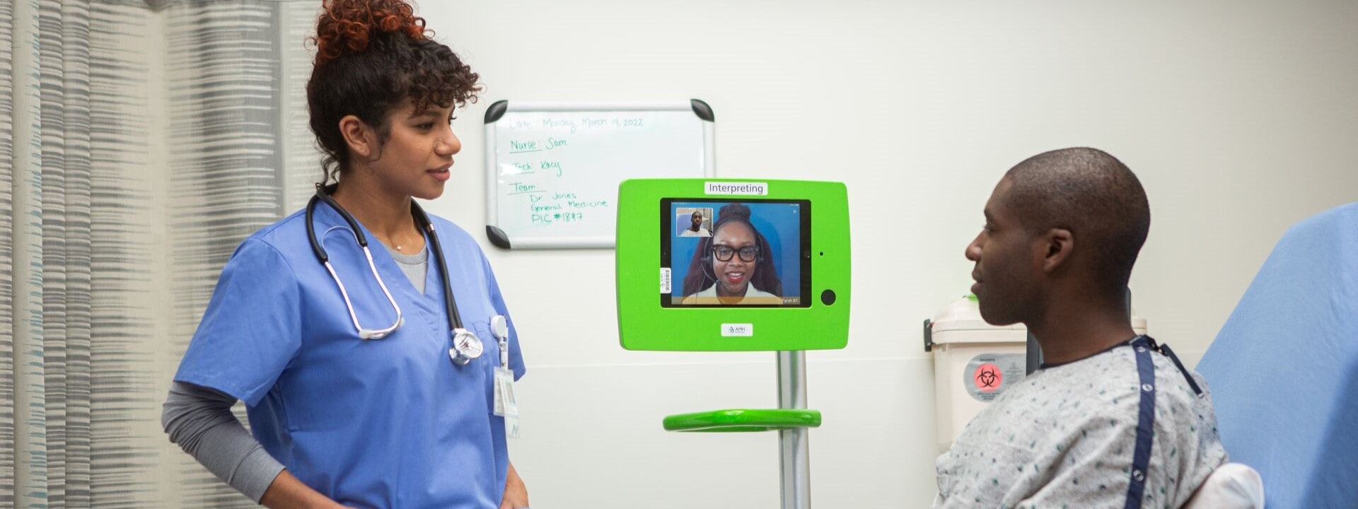 Clinician with LEP patient and an interpreter on a video monitor Clinician with LEP patient and an interpreter on a video monitor