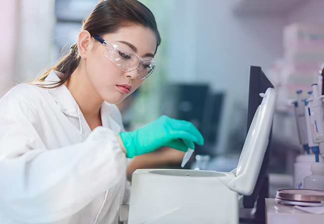 Lab technician using lab equipment Lab technician using lab equipment