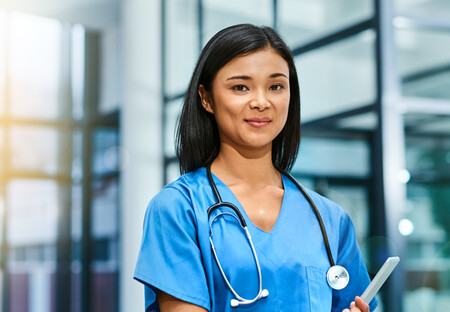 Nurse standing in front of hospital Nurse standing in front of hospital