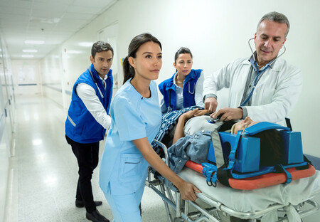 Trauma team rushing patient into operating room Trauma team rushing patient into operating room