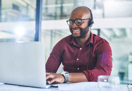 Business man with headset working on laptop Business man with headset working on laptop