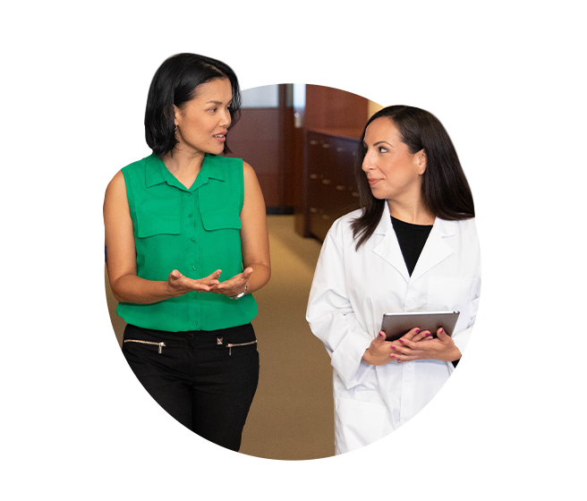 Business woman speaking to female physician Business woman speaking to female physician